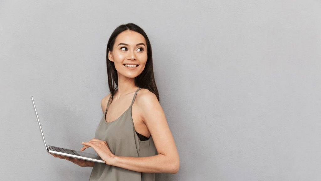 Woman holding a table looking over her left shoulder